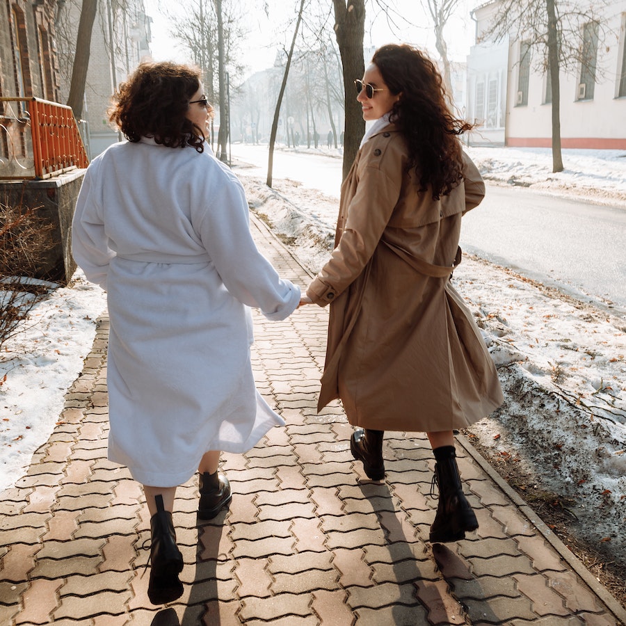 Women walking on the sidewalk holding hands