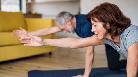 older couple does yoga at home