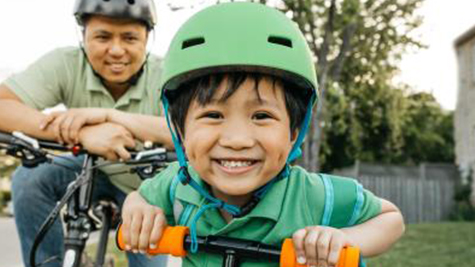 kids smiles with bike helmet on