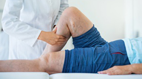 doctor bends patients knee