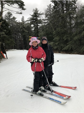 man and woman skiiing
