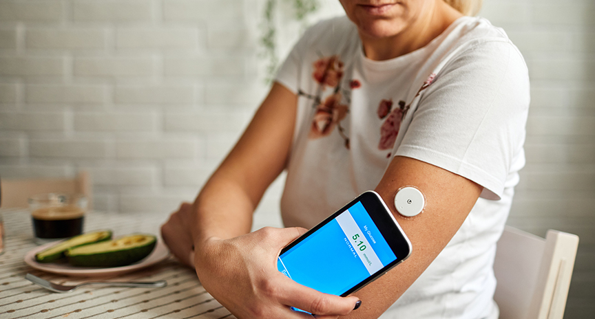 Woman with diabetes uses cellphone for continuous glucose monitoring
