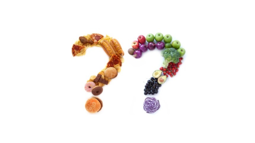 Processed foods and vegetables arranged in the shape of two question marks