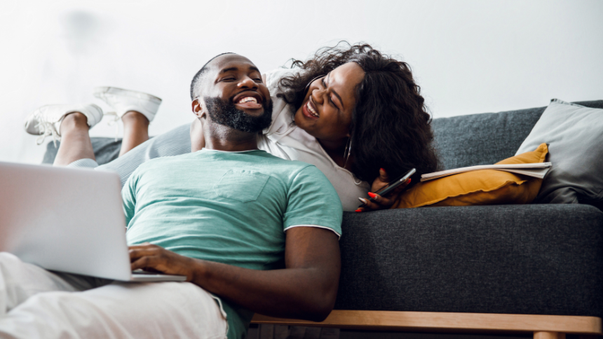 Happy young Black male and female smiling to each other while spending time at home because they know what if bariatric surgery is right for them.