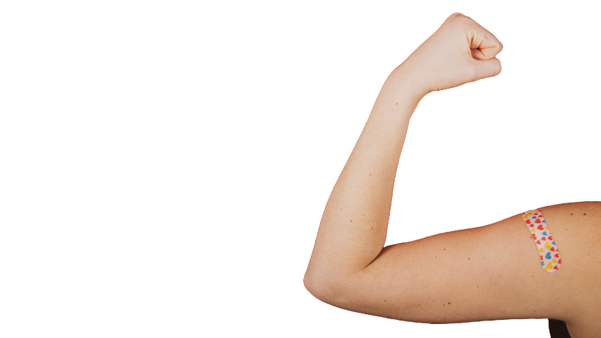 Someone making a muscle with their arm showing a band-aid with hearts on it on a white background.