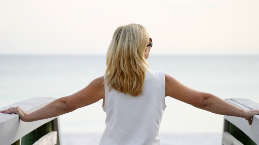Blond woman looking at ocean
