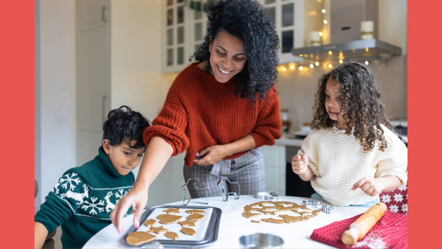 Young sister and brother making Christmas gingerbread cookies with their mother.