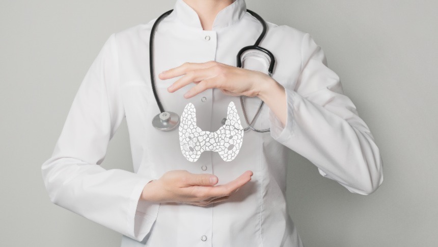 Image of doctor with hands holding thyroid gland design