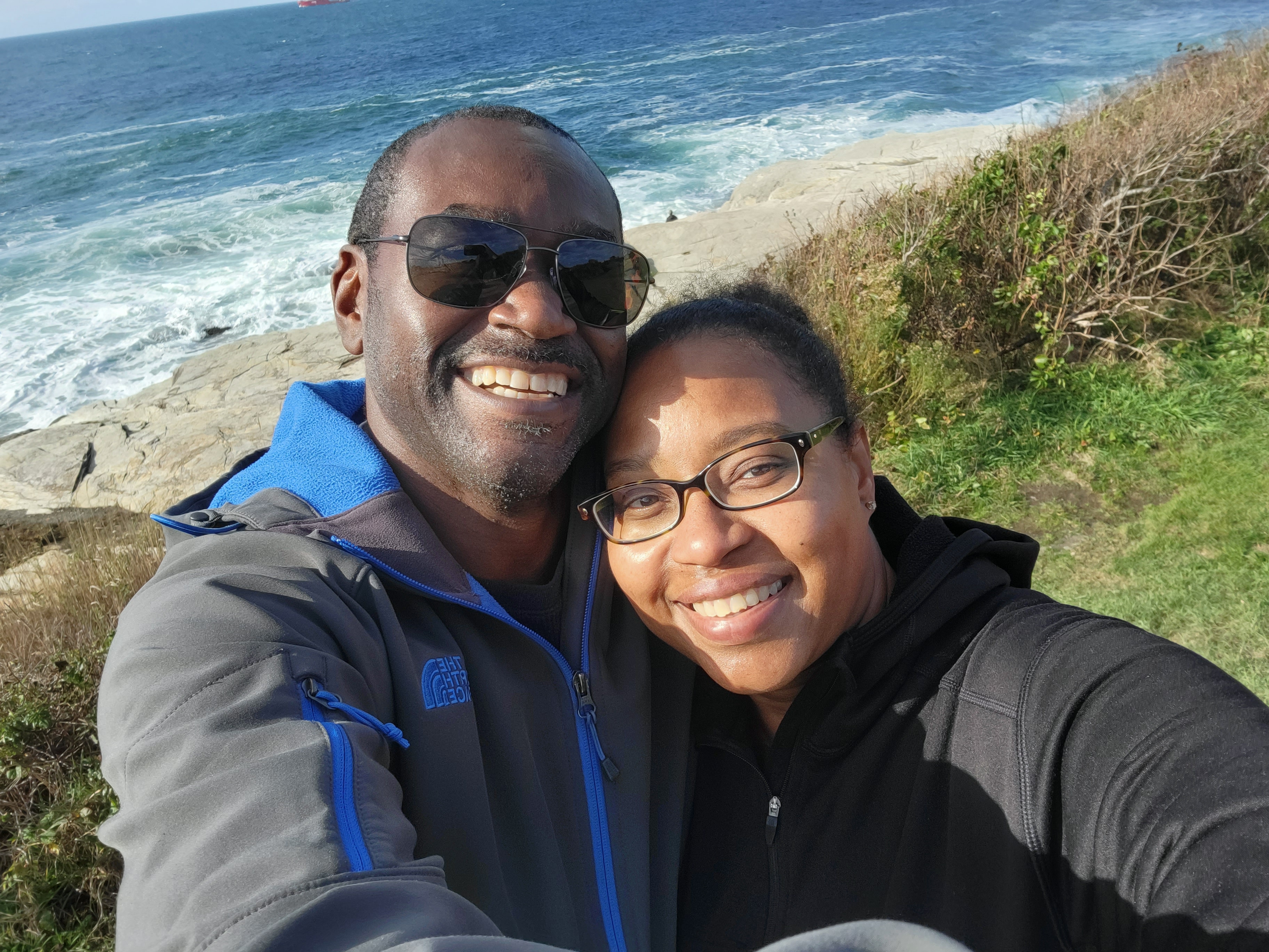 Leonie Roberts with her husband outside near the ocean.