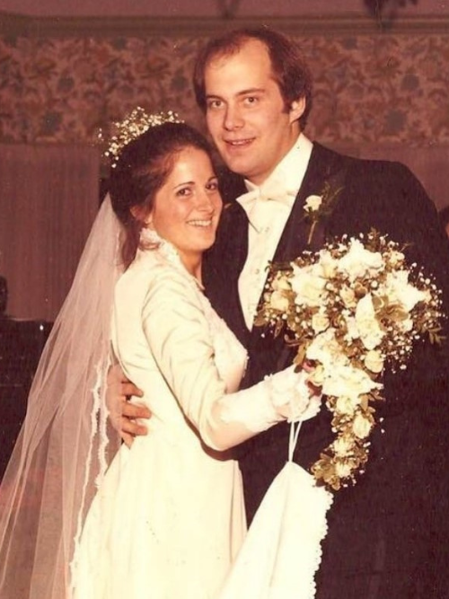 Lisa and Mike Foster in a wedding gown and tuxedo on their wedding day. 