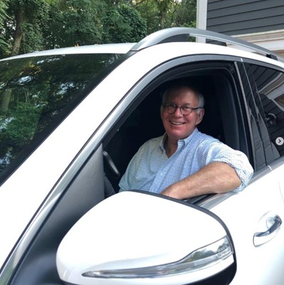 Mike Foster, a sixty-five-year-old man post-stroke in his voice command control car