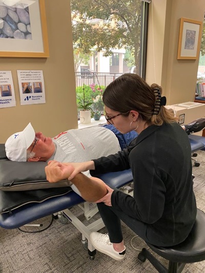 Mike Foster, a sixty-five-year-old man post-stroke in neuro rehabilitation with occupational therapist Alyssa Bond