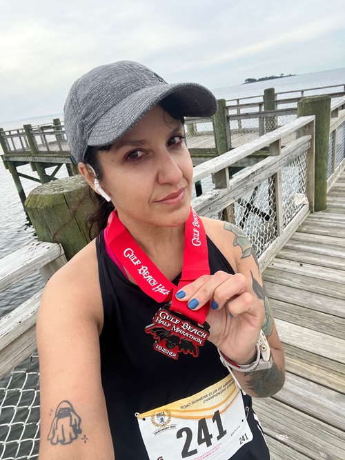 Carolina Herrera after running a half marathon in September 2023. Carolina Herrera, Norwalk Hospital spinal fusion patient, holding a metal from a half marathon in September 2023.