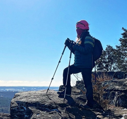 Carolina Herrera, Norwalk Hospital spinal fusion patient, standing on a rock during a hike.