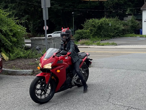 Carolina Herrera, Norwalk Hospital spinal fusion patient, sitting on her motorcycle.