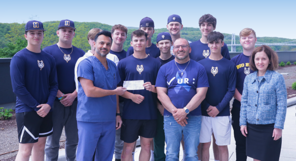 Dr. Pranat Kumar, Colorectal Surgeon (left), John Manganiello (middle), Susan Browning, President, VBMC (right) with John’s high school baseball players