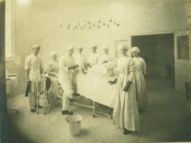 Surgeon and nurses surround an operating room table at Vassar Brothers Medical Center in 1913