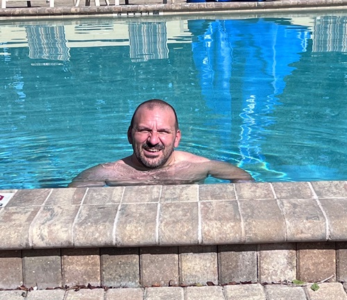 VBMC colon cancer patient John Manganiello in a swimming pool.