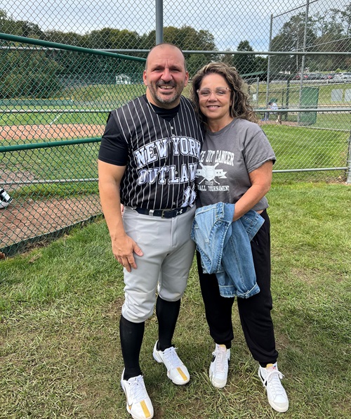 VBMC colon cancer patient John Manganiello with wife on the baseball field.