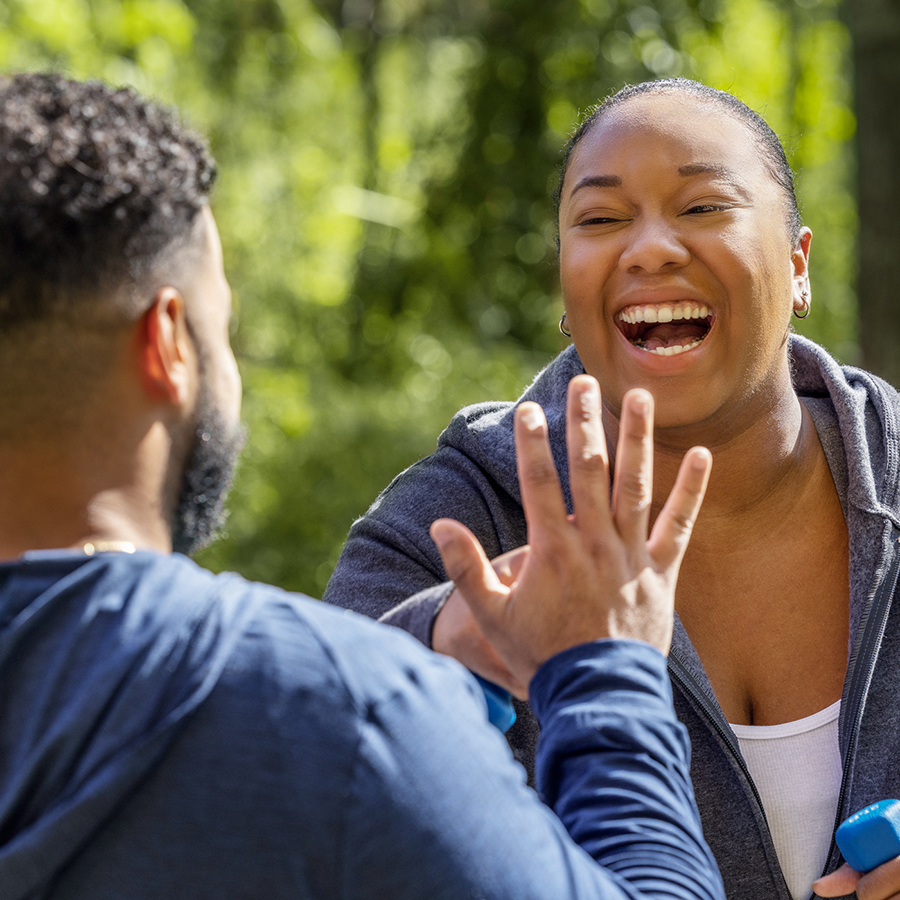 Couple throwing a high-five while exercising 