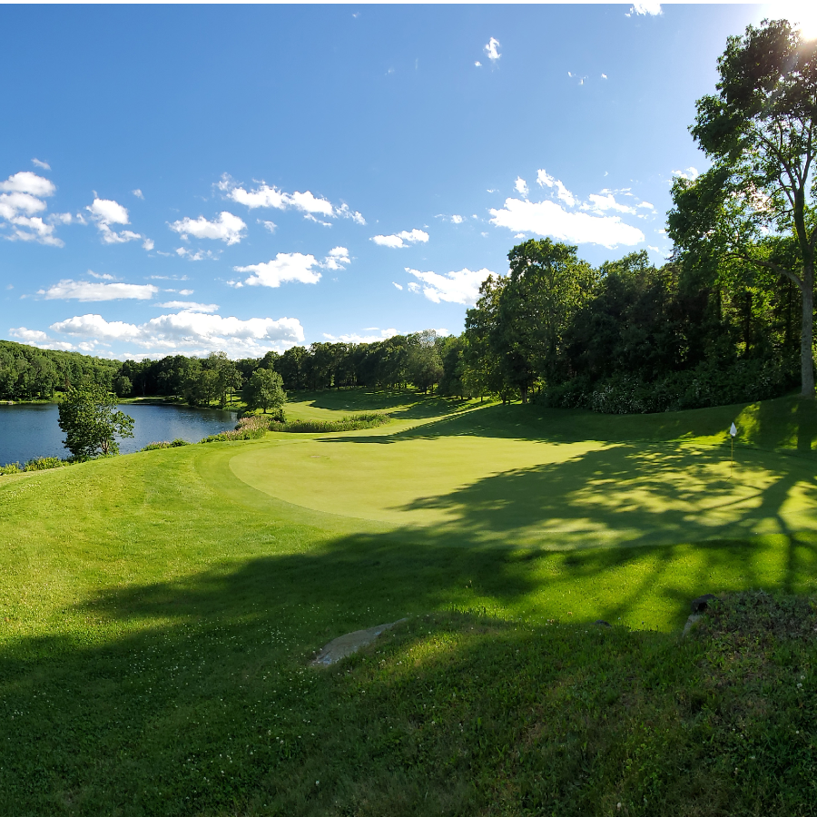 View of a golf course next to a lake