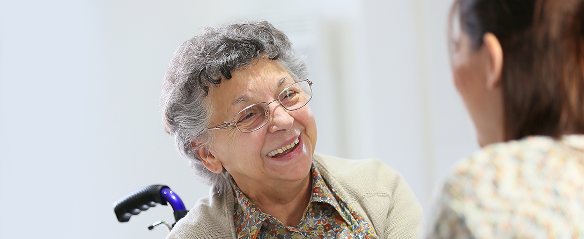 senior woman smiles at caregiver