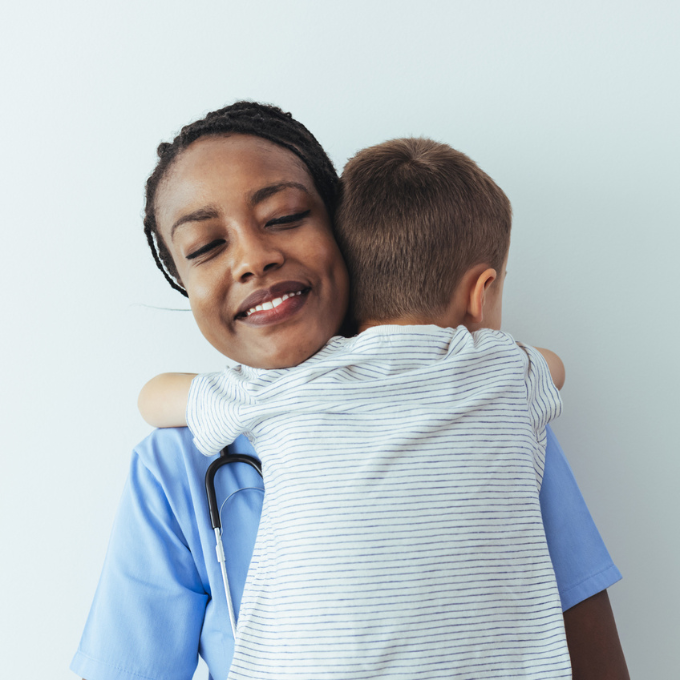 Happy boy hugging his clinician after appointment 