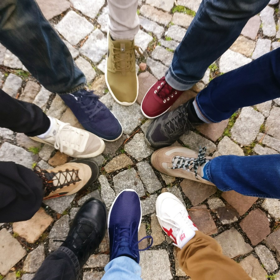 Group of people with shoes forming a circle