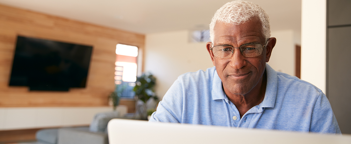 older man looks at computer screen