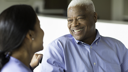 male smiles at care nurse