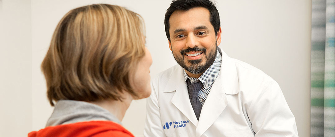 male doctor happily talks to patient