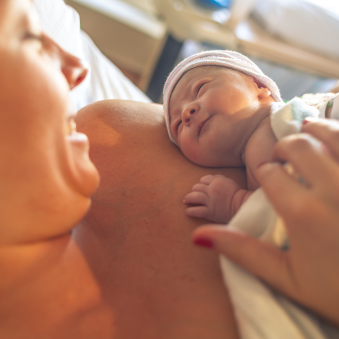 woman holds her newborn infant