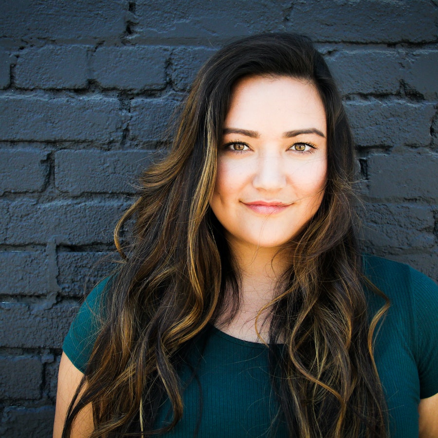 Close up of woman in front of a blue wall