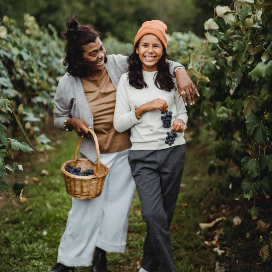 Gardener with her daughter in a vineyard 