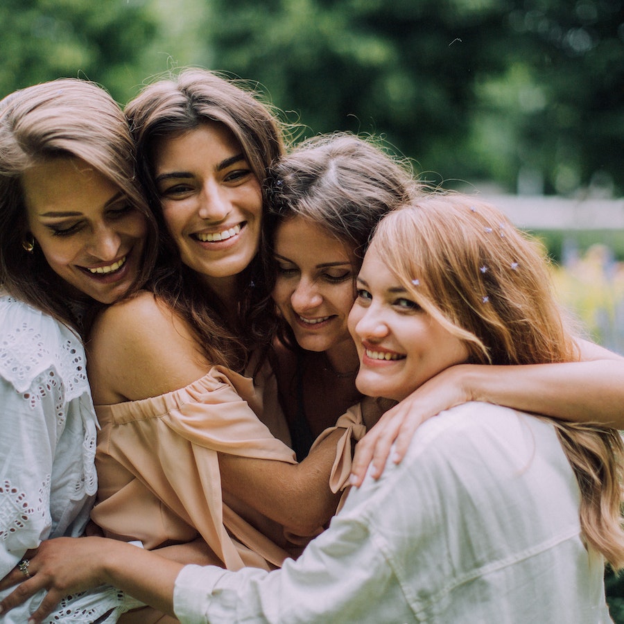 Group of four women hugging