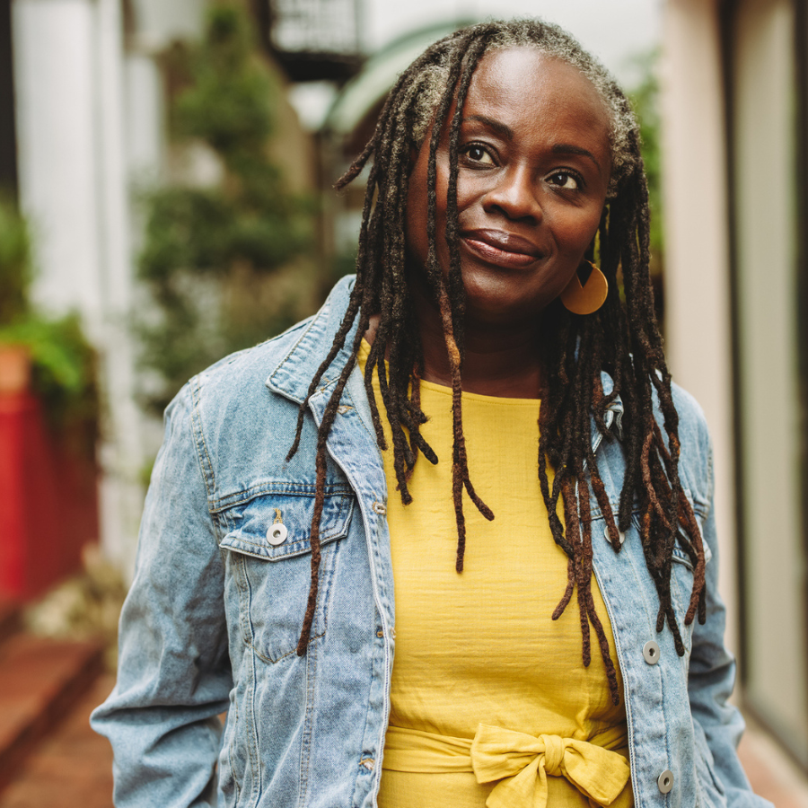 Mature woman with dreadlocks standing outdoors