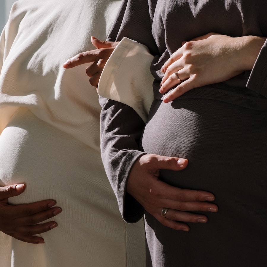 Pregnant women in long sleeve dresses