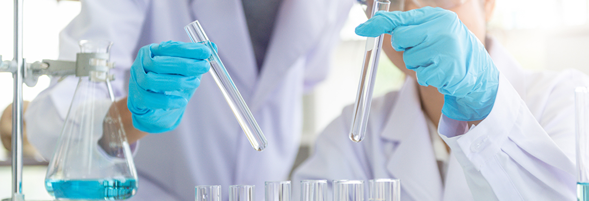 research scientists looking at test tubes