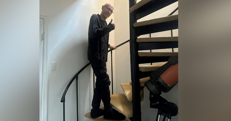 Michael giving a thumbs up as he makes his way up his spiral staircase!