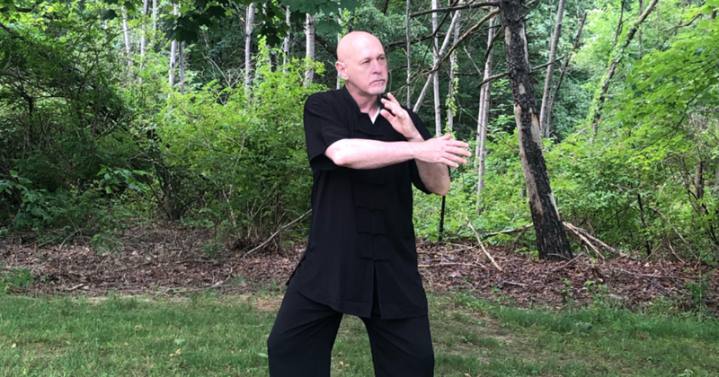 Michael practicing tai chi outdoors.