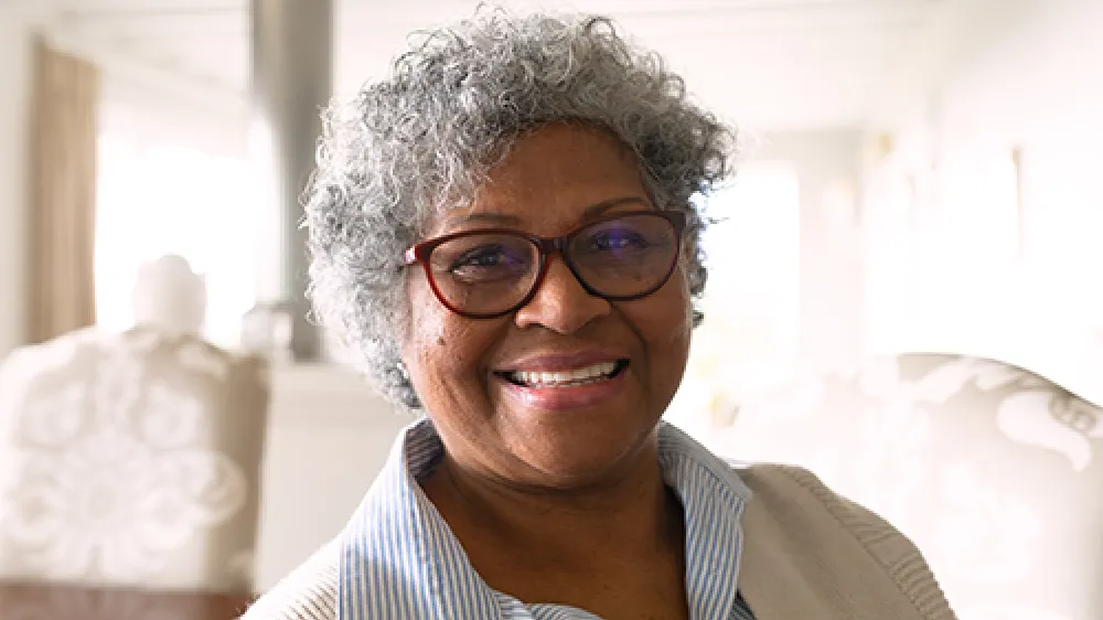 Older woman with glasses smiling