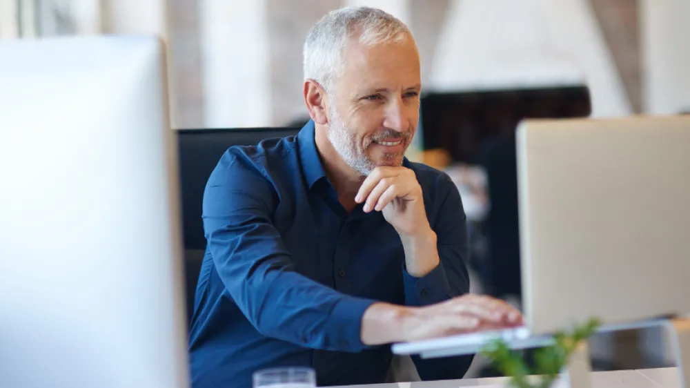 Man sitting in front of a laptop