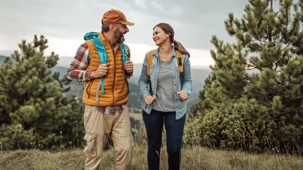Happy couple on hiking trail.