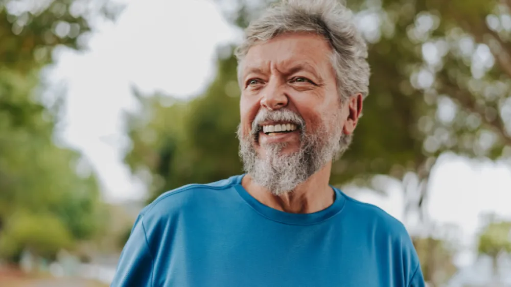 Hero Portrait of a happy Caucasian senior man in nature