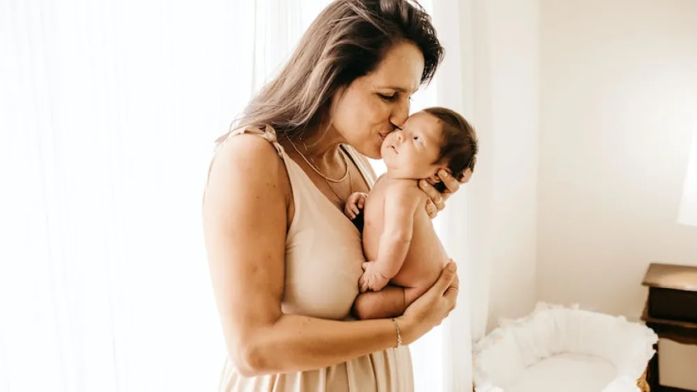 Mother kissing her baby 860x484
