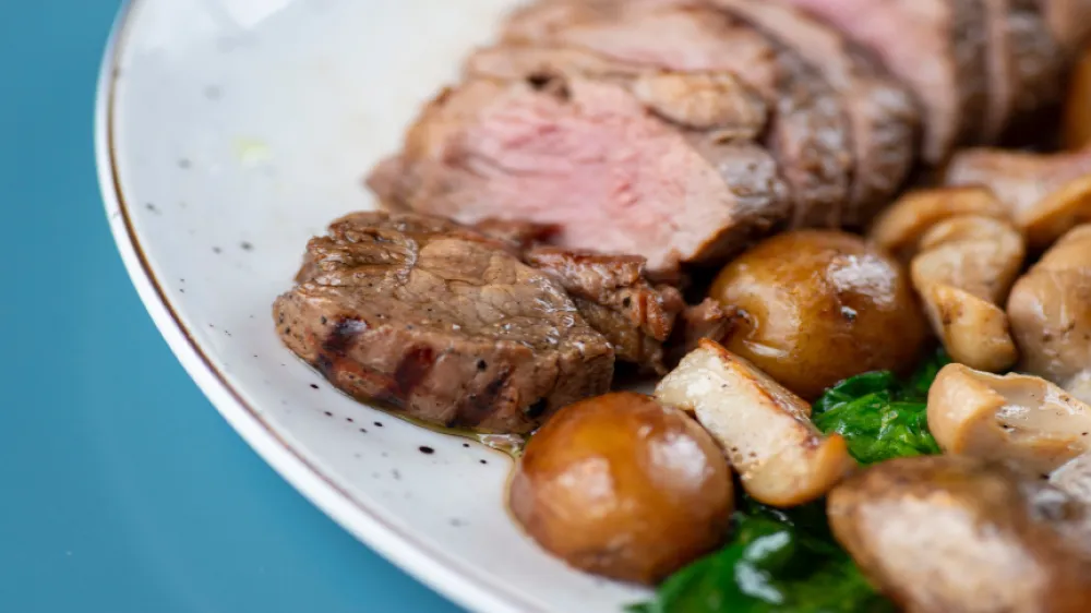 Plate of roast meat potatoes and vegetables
