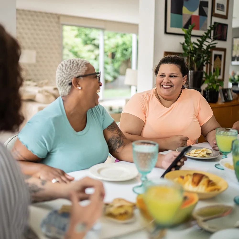Women sitting around the table socializing and laughing